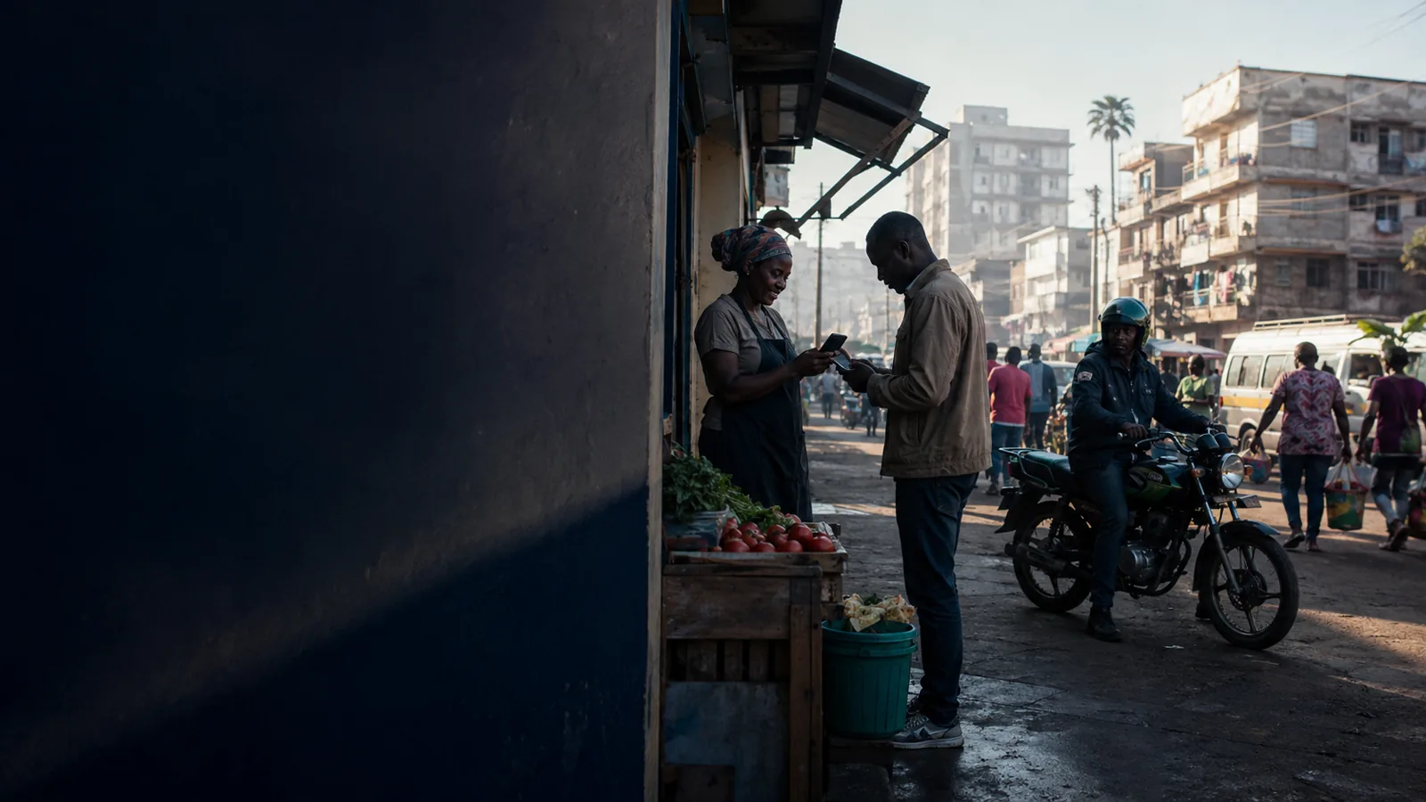 A woman checking her phone at a market stall in bright daylight.